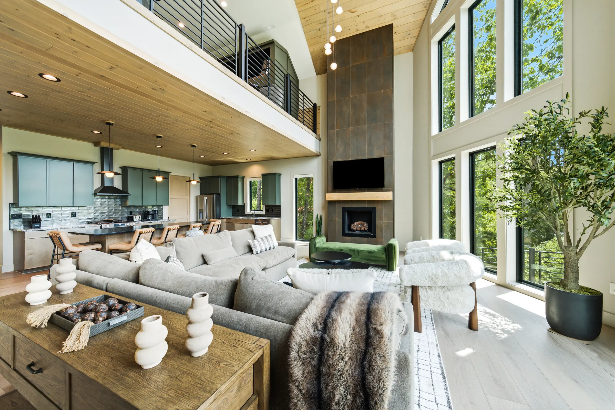 Sunlit Milk and Honey great room with double-height windows and mountain views