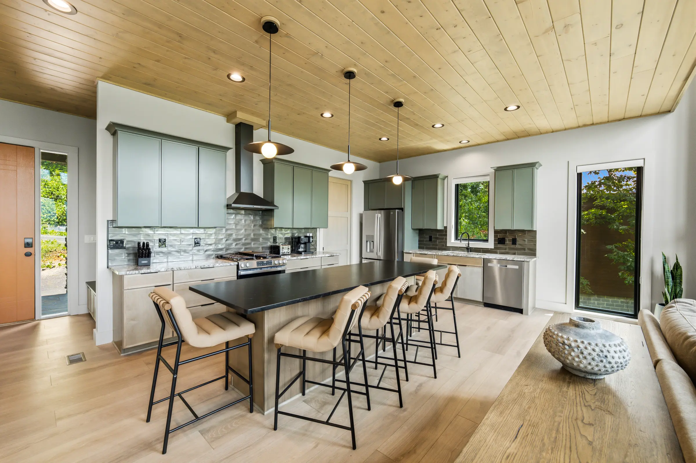 Pale wood kitchen beneath a slatted ceiling at Milk and Honey