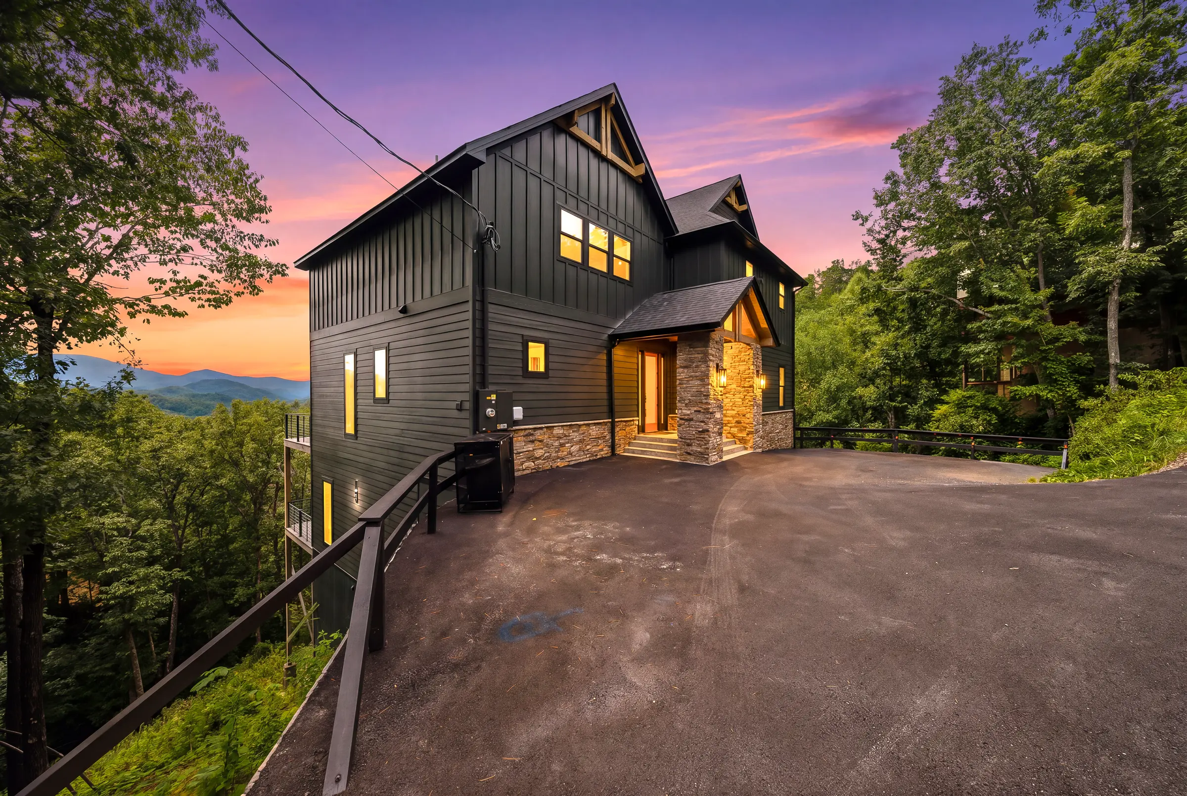 Milk and Honey exterior glowing against a Smoky Mountain sunset