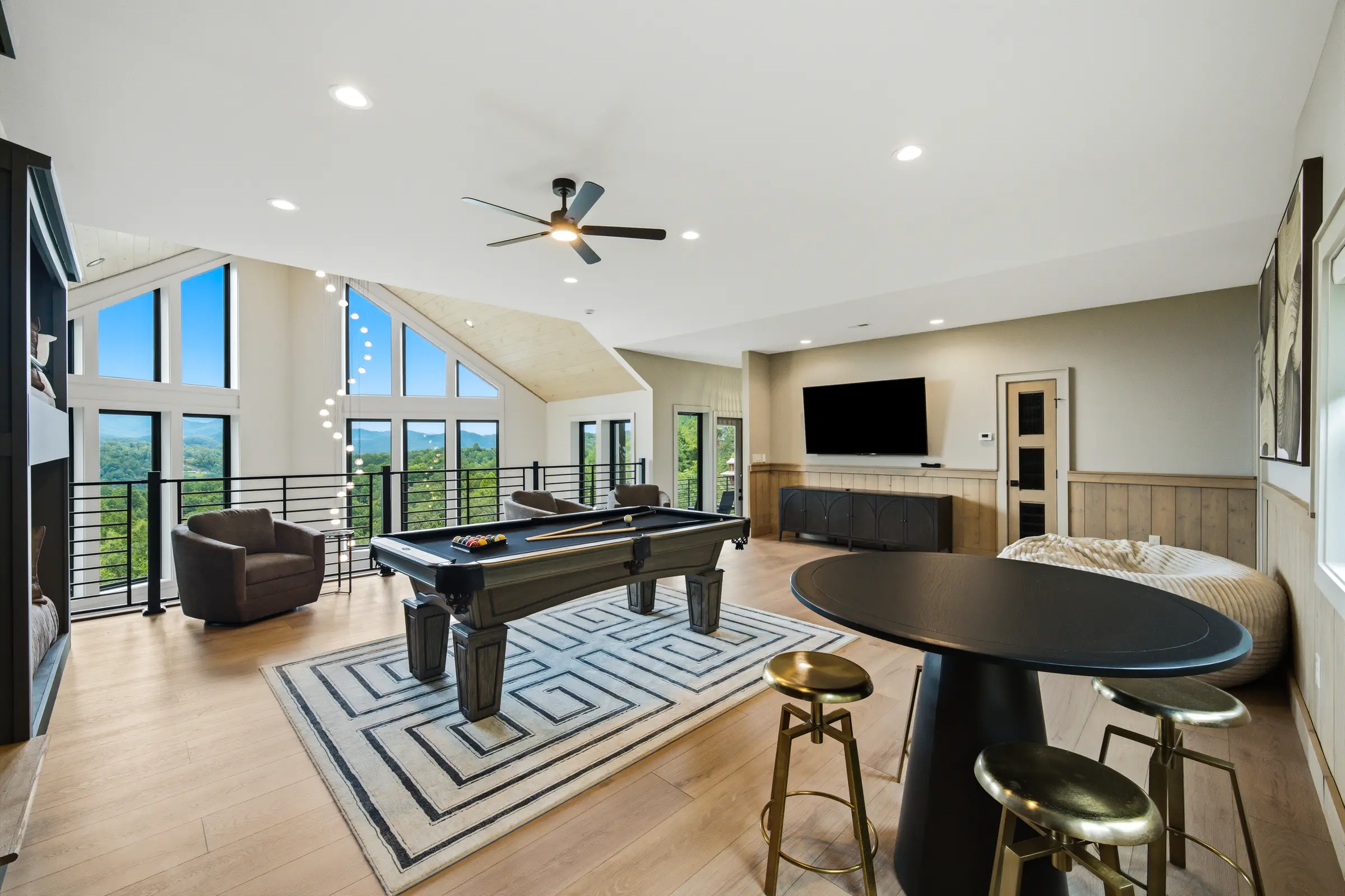 Game room with billiards, shuffleboard, and mountain-facing windows