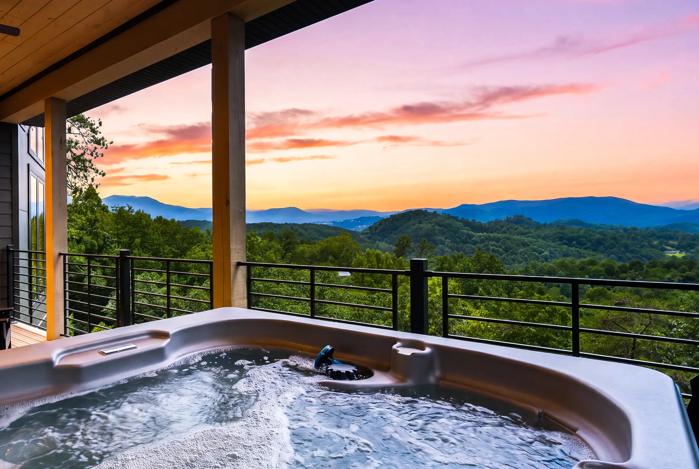 Hot tub framed against a layered Smoky Mountain sunset