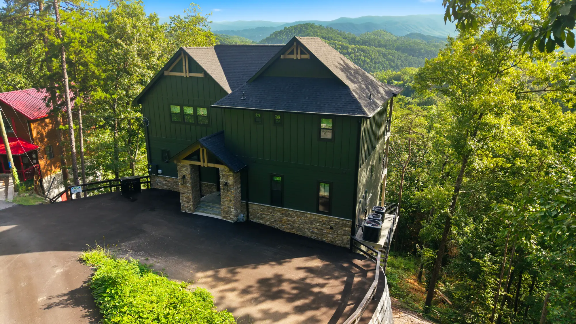 Aerial arrival view of Milk and Honey surrounded by wooded mountain terrain