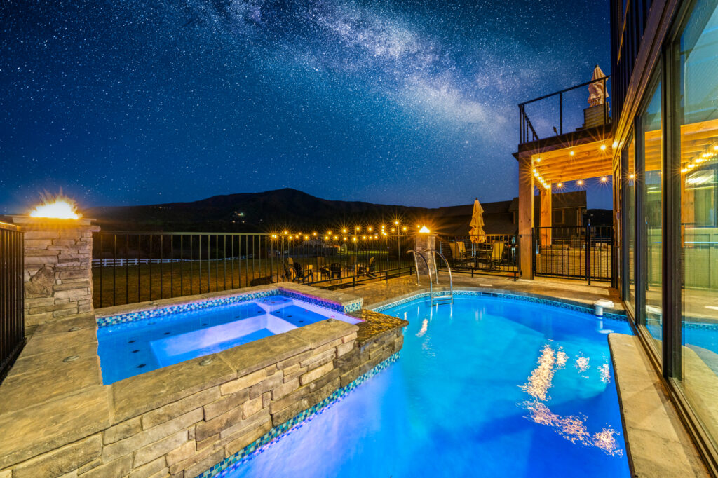Night time photo of a private pool at a luxury STR listing photographed in Wears Valley TN