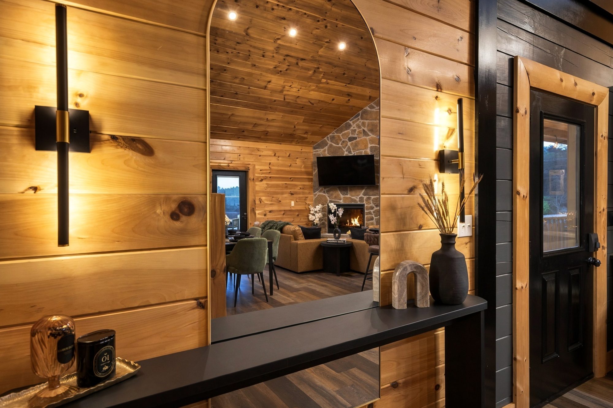 Hallway mirror framing a great room with the fireplace lit, The Forge, Pigeon Forge