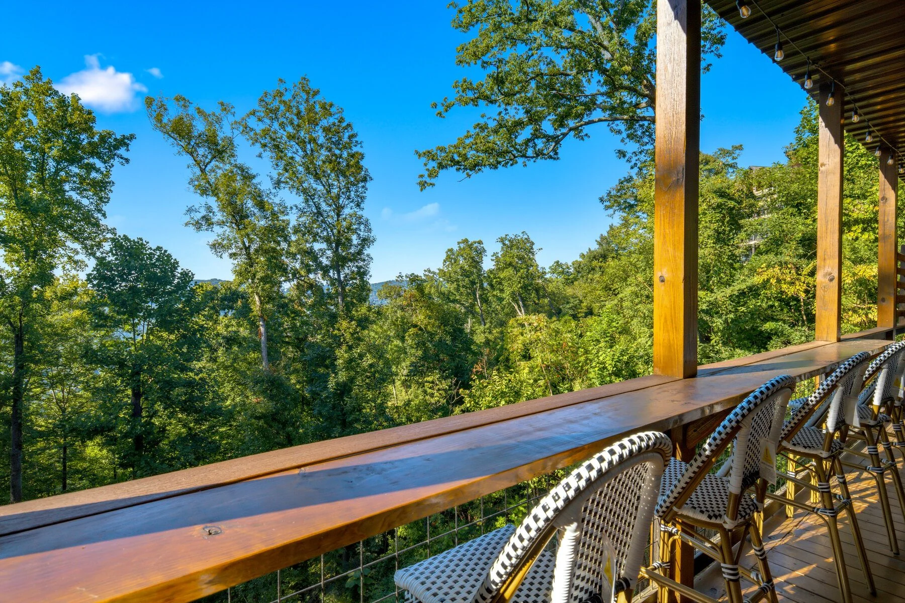Covered deck seating and the mountain view at The Forrest House in Gatlinburg
