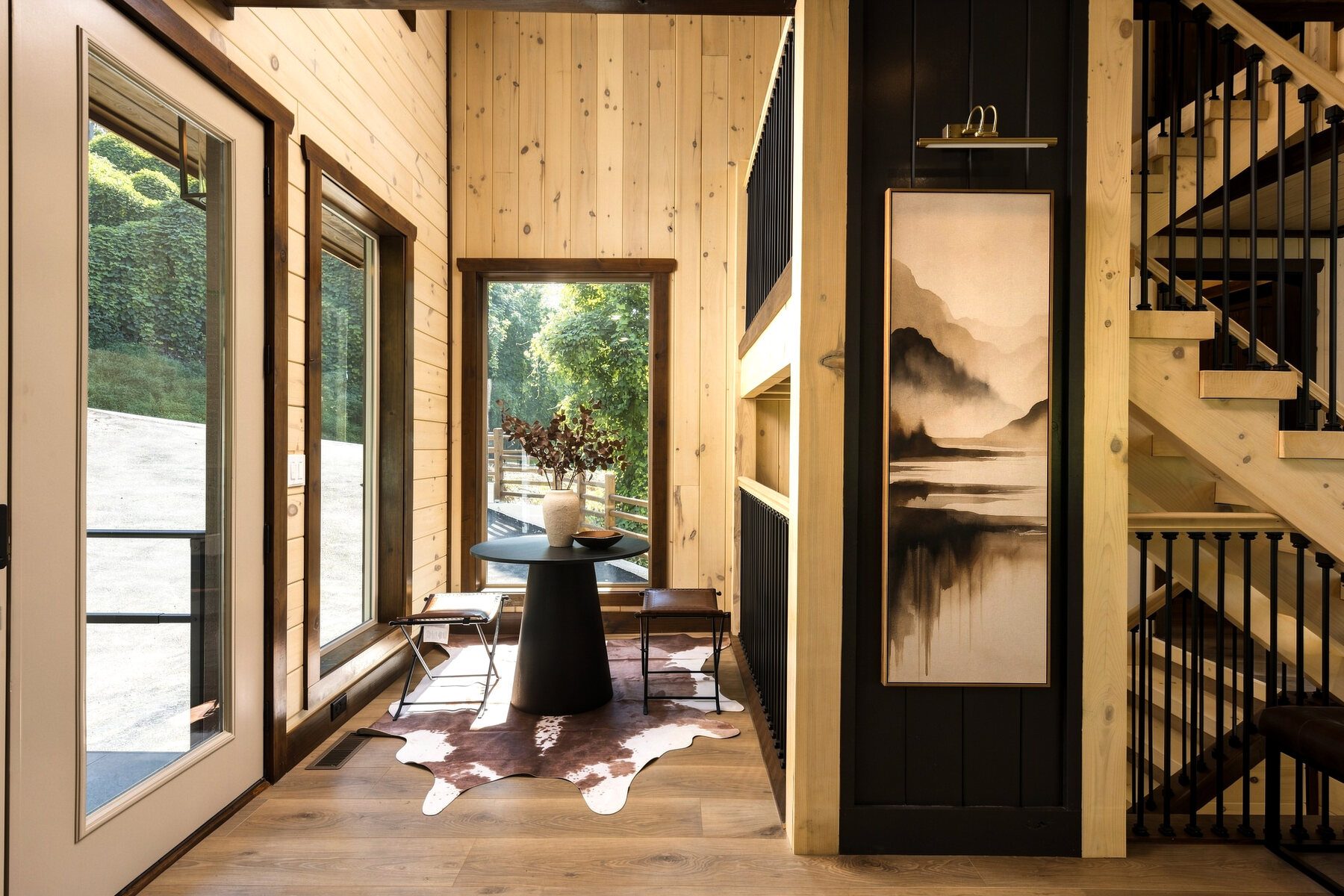 Sunlit sitting and work area alongside the tall windows