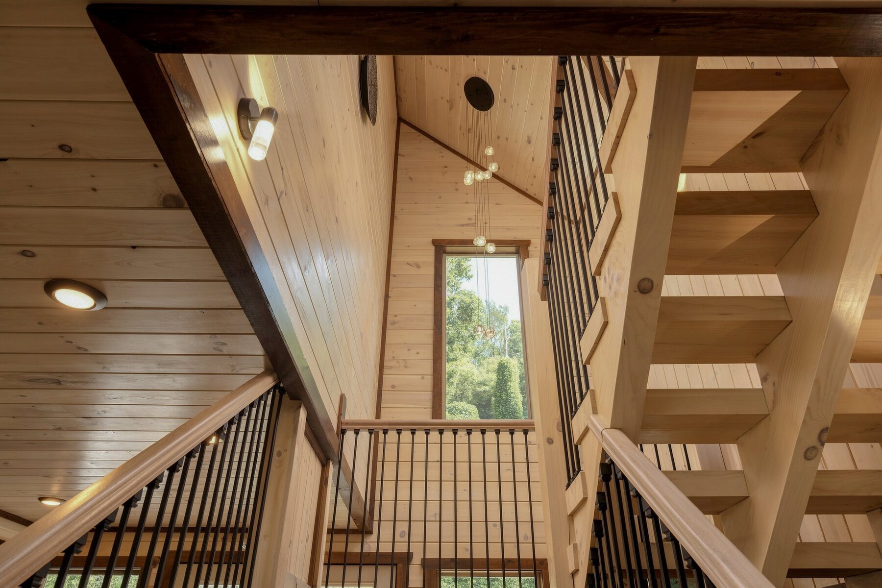 Timber stairwell with black iron railing