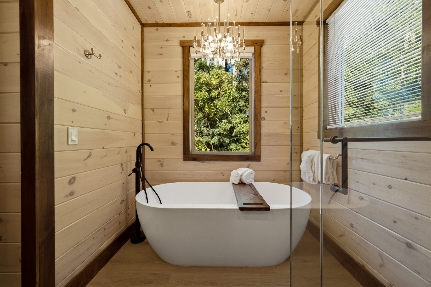 Bright bath with freestanding tub and wooded outlook