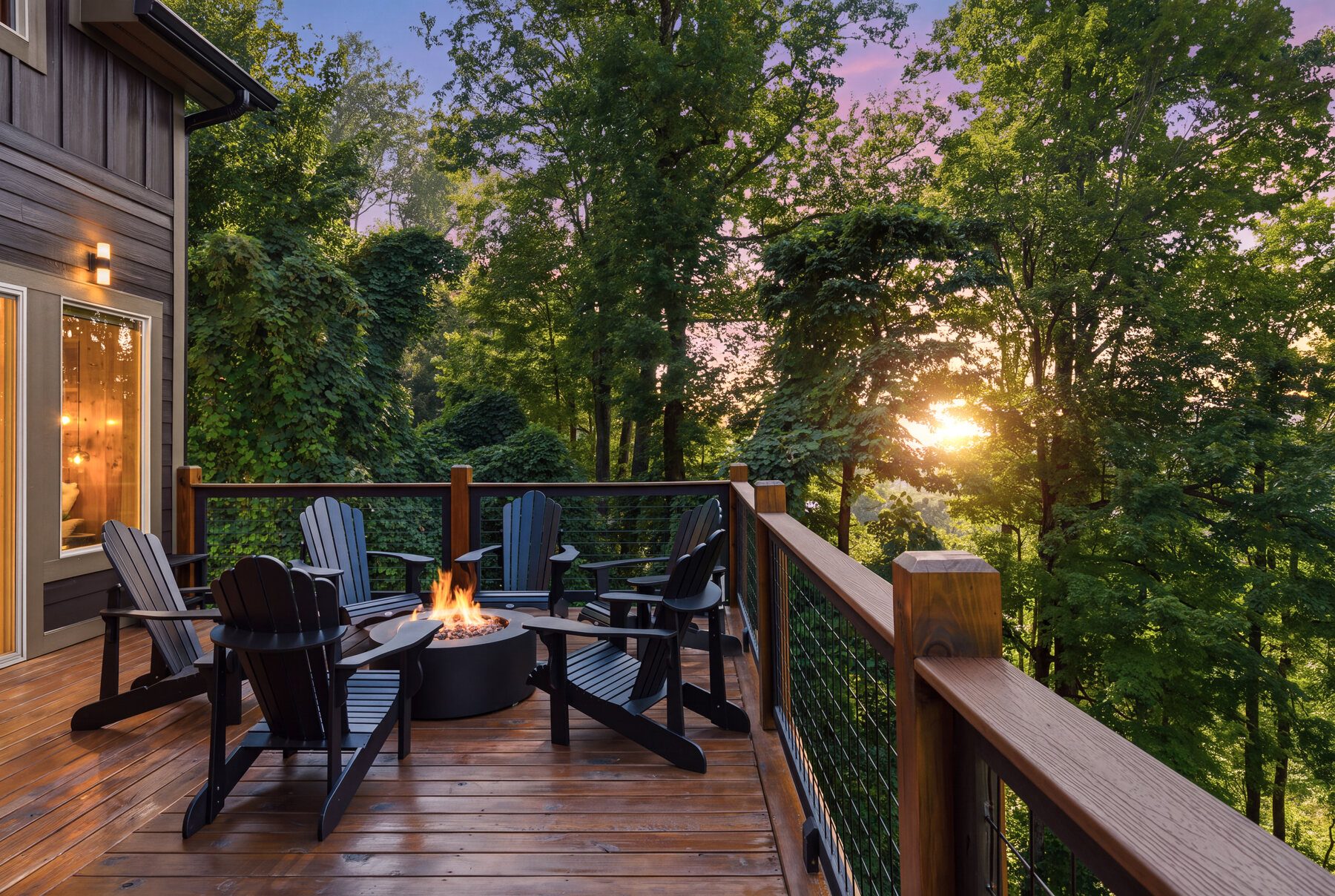 Fire pit deck surrounded by trees in late-day light