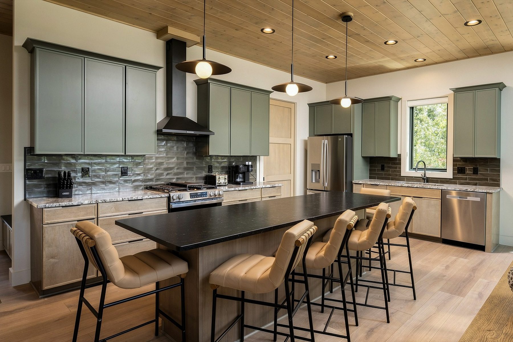 Kitchen island and cabinetry beneath warm timber planks