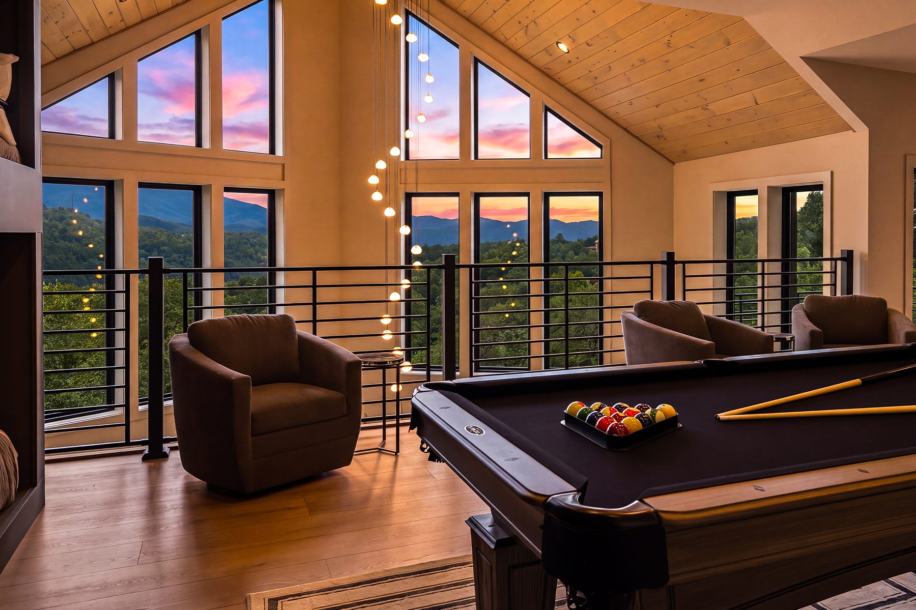 Billiards area positioned beneath the dramatic gable windows