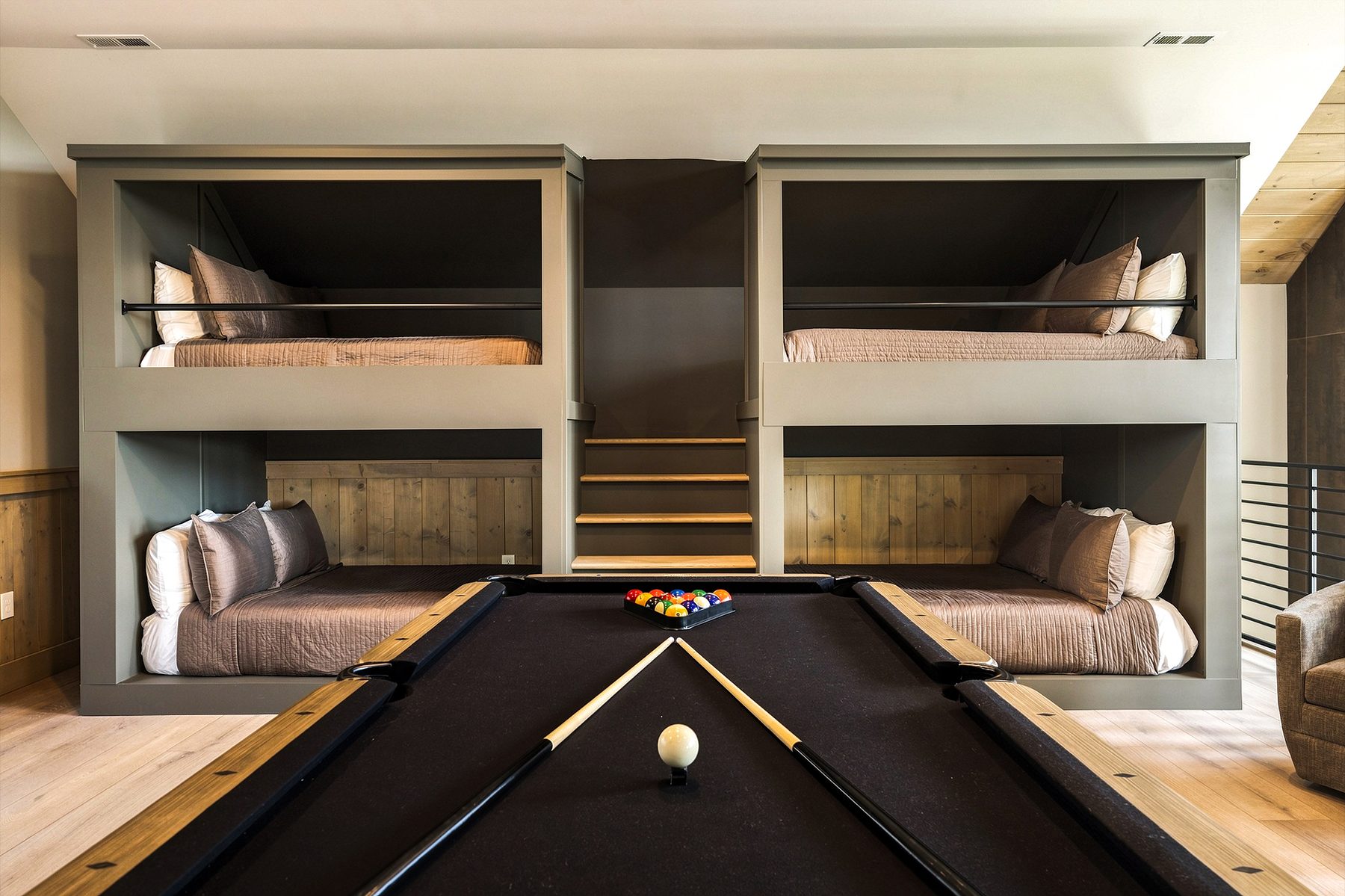 Built-in bunk beds framing the billiards table