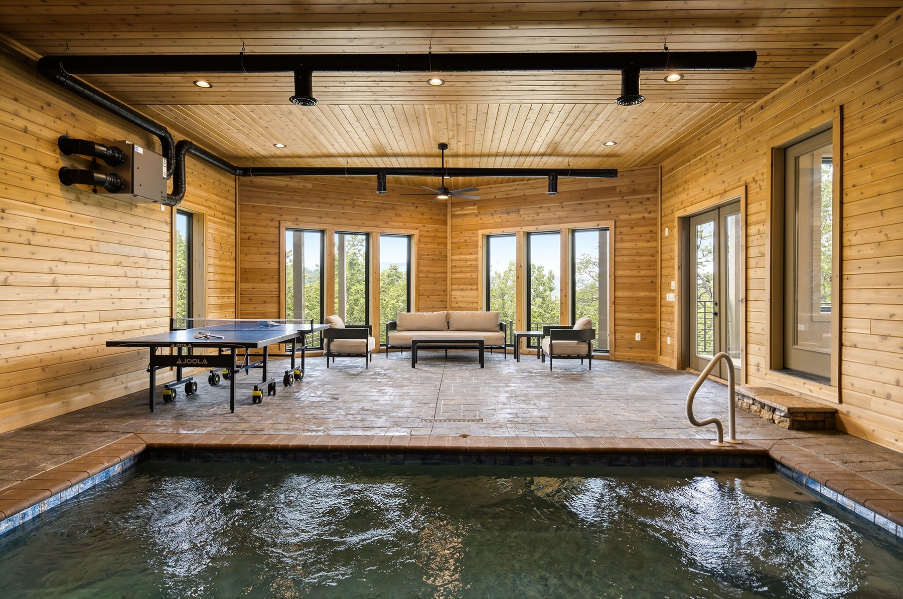 Indoor pool room wrapped in warm timber