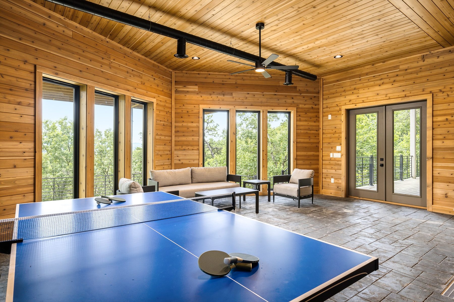 Table-tennis area with multiple doors to the surrounding decks