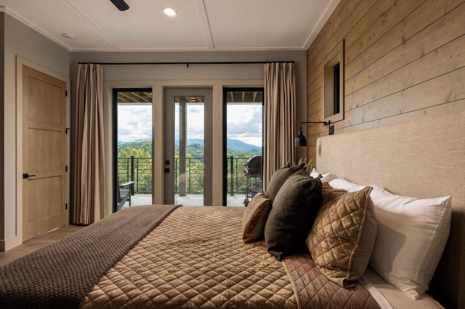 Timber-accented bedroom looking toward the mountains