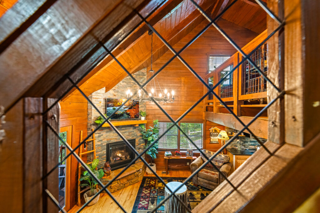 Living room area photographed through staircase mesh for an STR listing in Sevierville TN