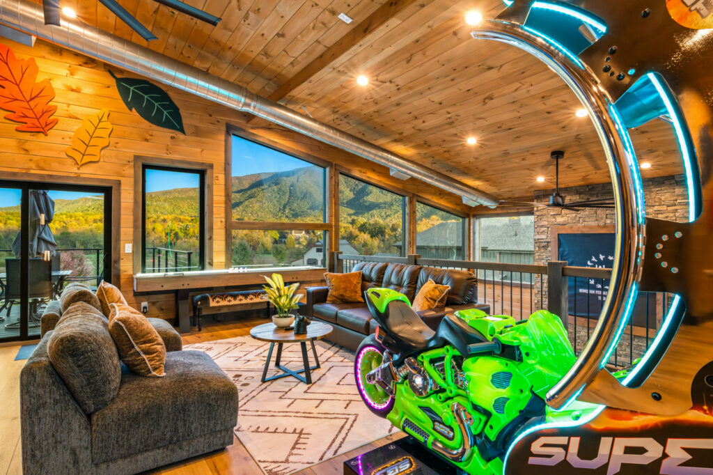 Upstairs game room with indoor slide and arcade games showcasing an amazing view of Wears Valley Mountains photographed in Pigeon Forge TN