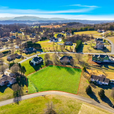 Aerial drone shot of a vacant lot for sale with property border line overlays photographed in Kodak TN