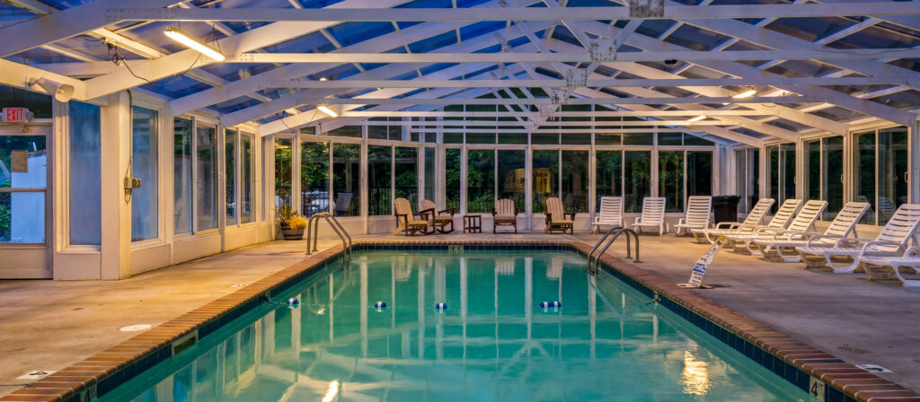 Indoor community pool photographed at night for a short-term rental property